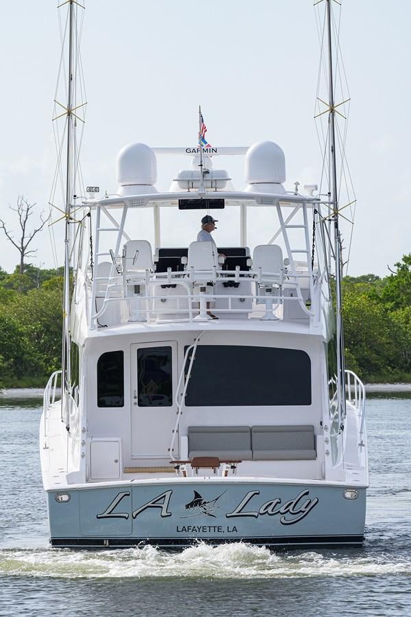 a white boat with a person on it aboard 68 CONVERTIBLE Yacht for Sale