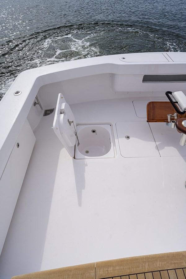a white boat with a wooden handle aboard 68 CONVERTIBLE Yacht for Sale
