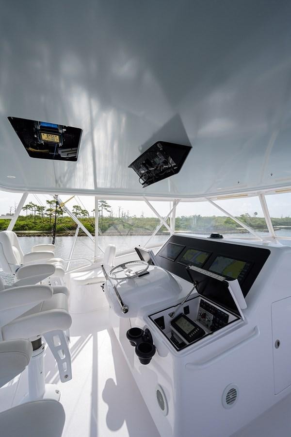a white table with chairs and a black box on it aboard 68 CONVERTIBLE Yacht for Sale