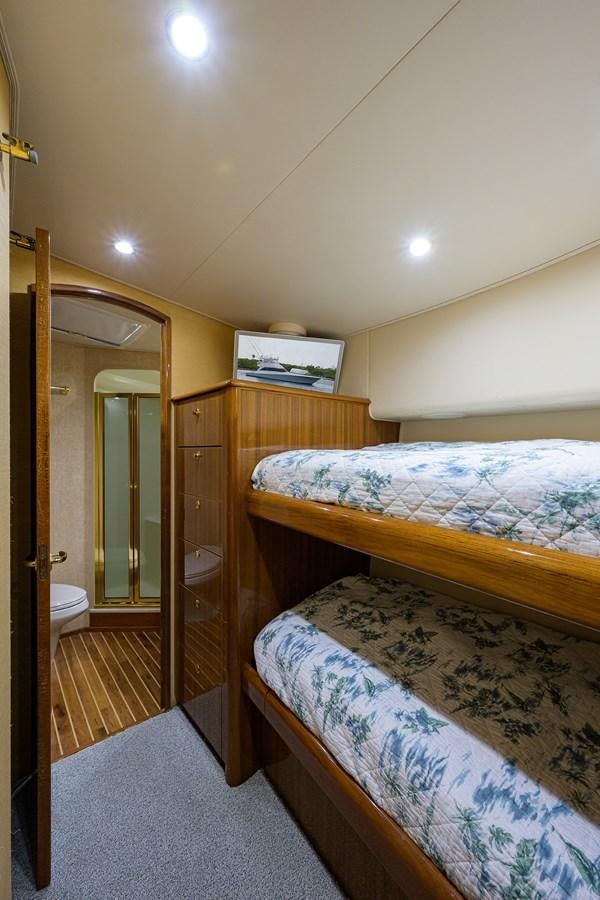 a bedroom with a bed and a closet aboard 68 CONVERTIBLE Yacht for Sale
