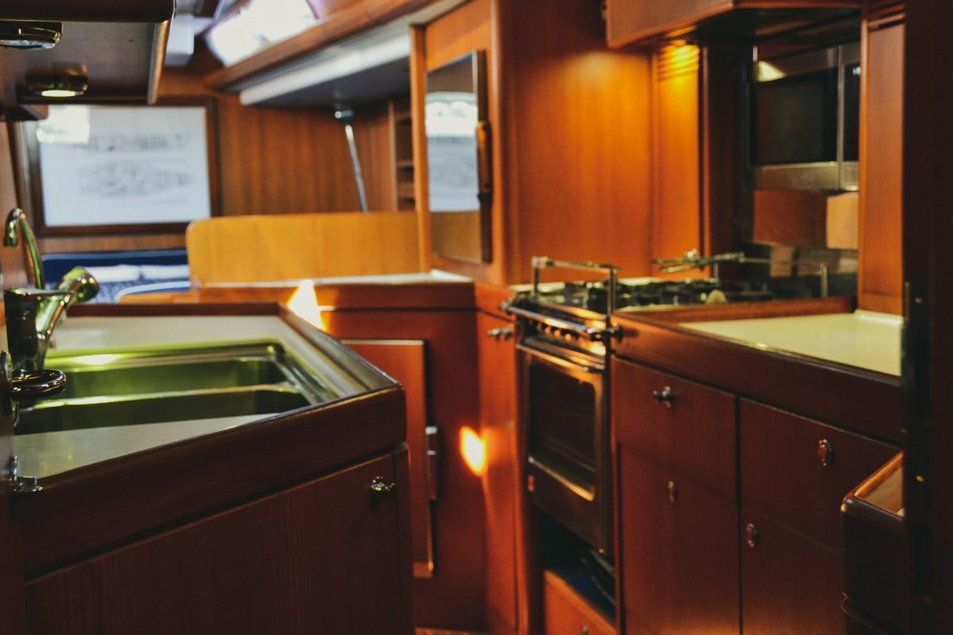a kitchen with wooden cabinets aboard DESIRADE III Yacht for Sale