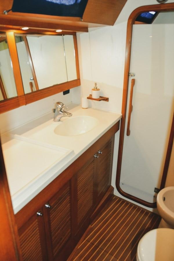 a bathroom with a sink and a mirror aboard DESIRADE III Yacht for Sale