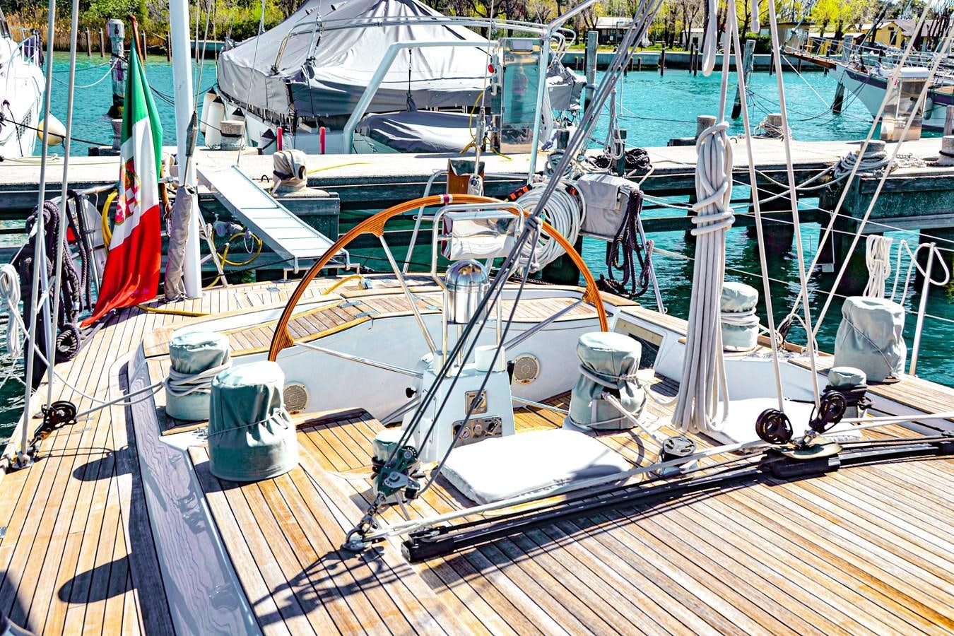 a boat with a flag on the front aboard DESIRADE III Yacht for Sale