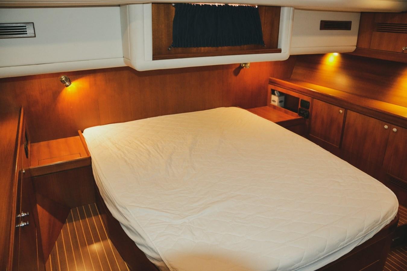 a bed in a room aboard DESIRADE III Yacht for Sale