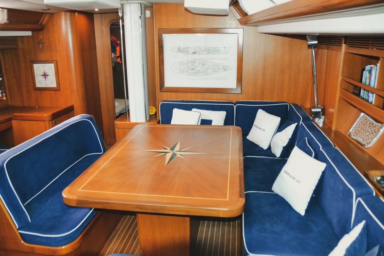 a room with a table and chairs aboard DESIRADE III Yacht for Sale