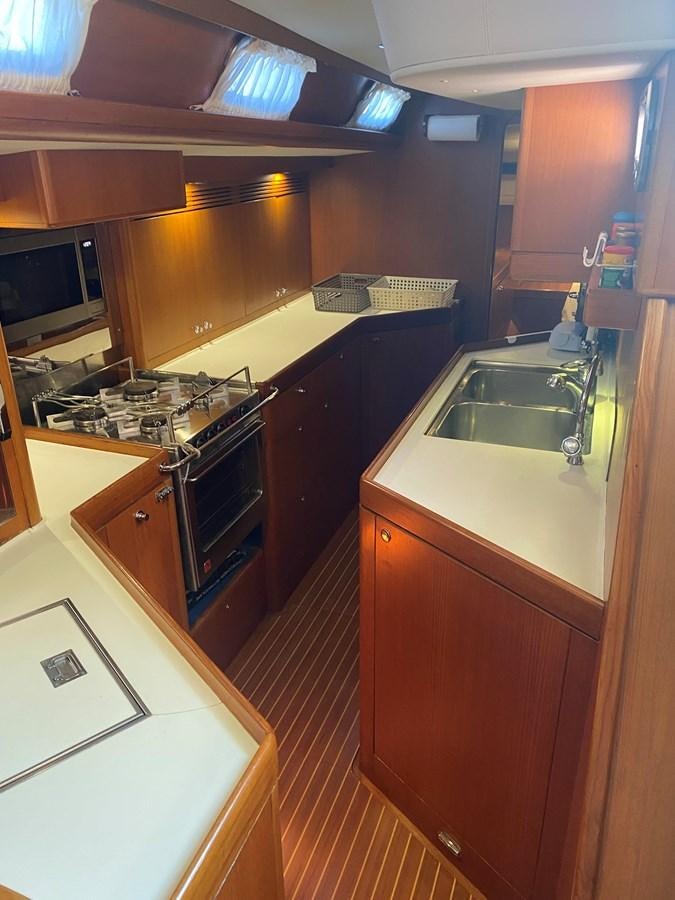 a kitchen with a stove and sink aboard DESIRADE III Yacht for Sale