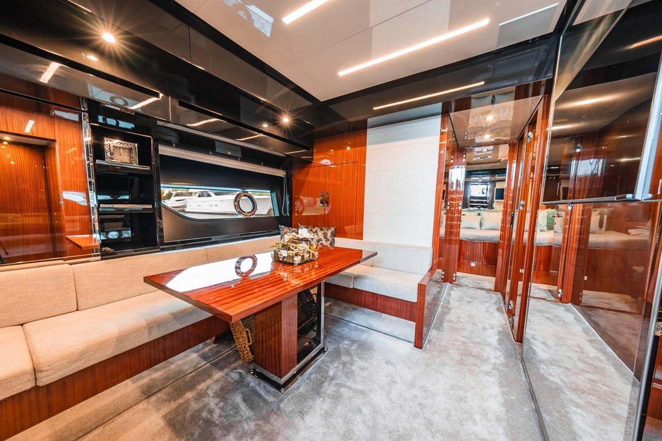 a room with a table and couch aboard REGENCY Yacht for Sale