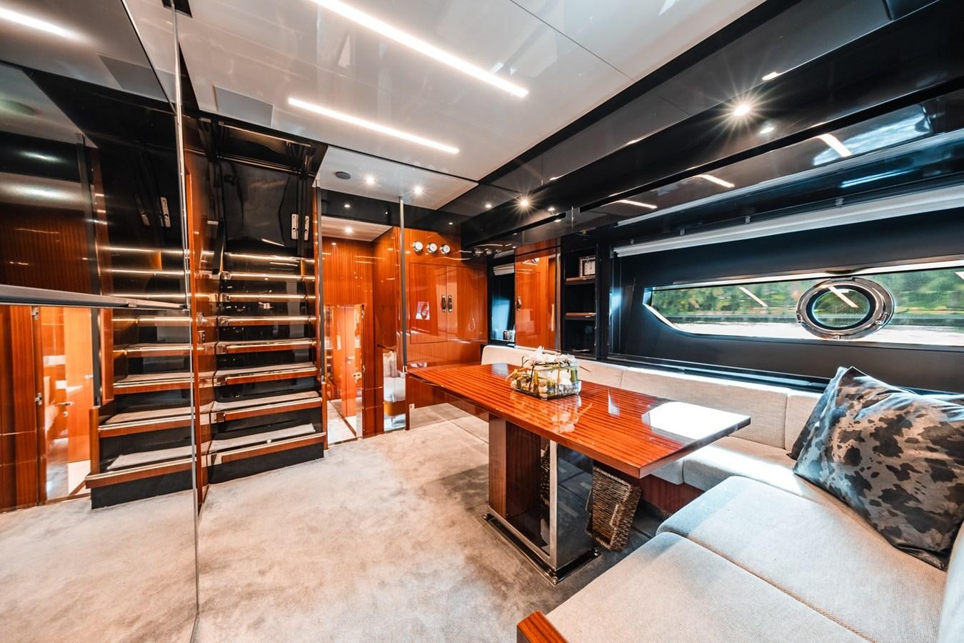 a room with a table and a couch aboard REGENCY Yacht for Sale