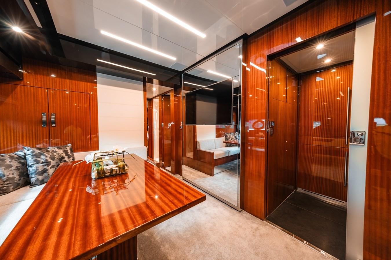a room with a table and couches aboard REGENCY Yacht for Sale