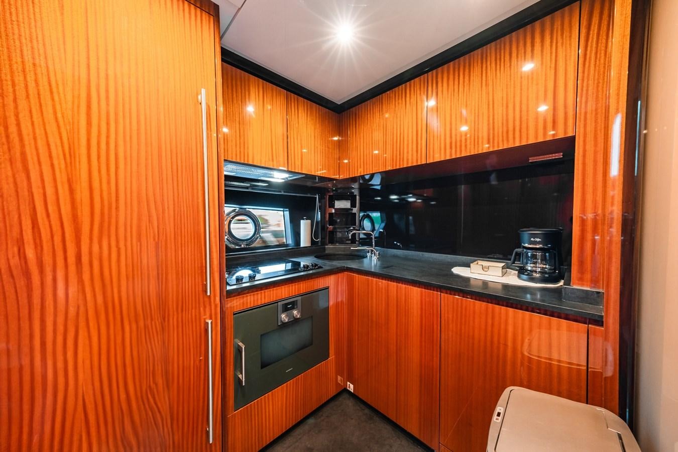 a kitchen with wooden cabinets aboard REGENCY Yacht for Sale