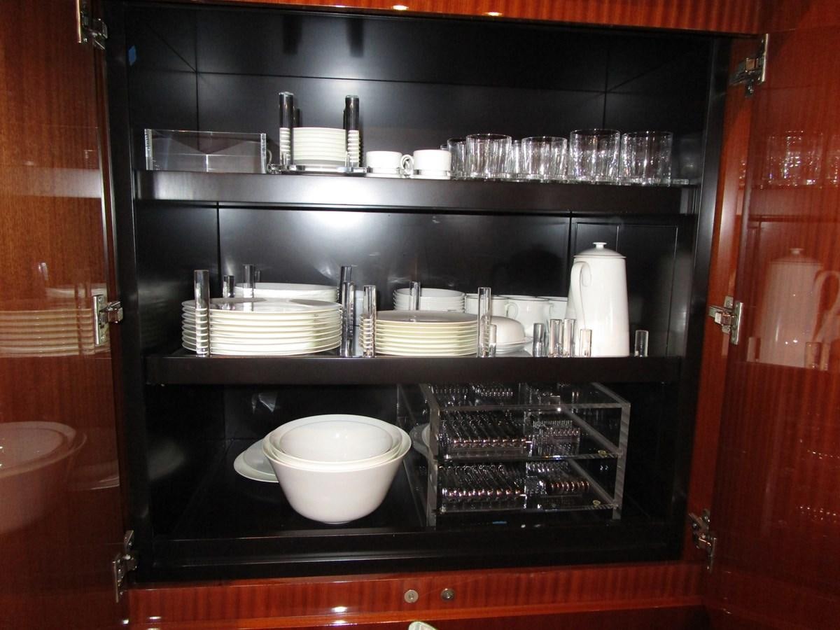 a kitchen with a white bowl and a white bowl on a black counter aboard REGENCY Yacht for Sale