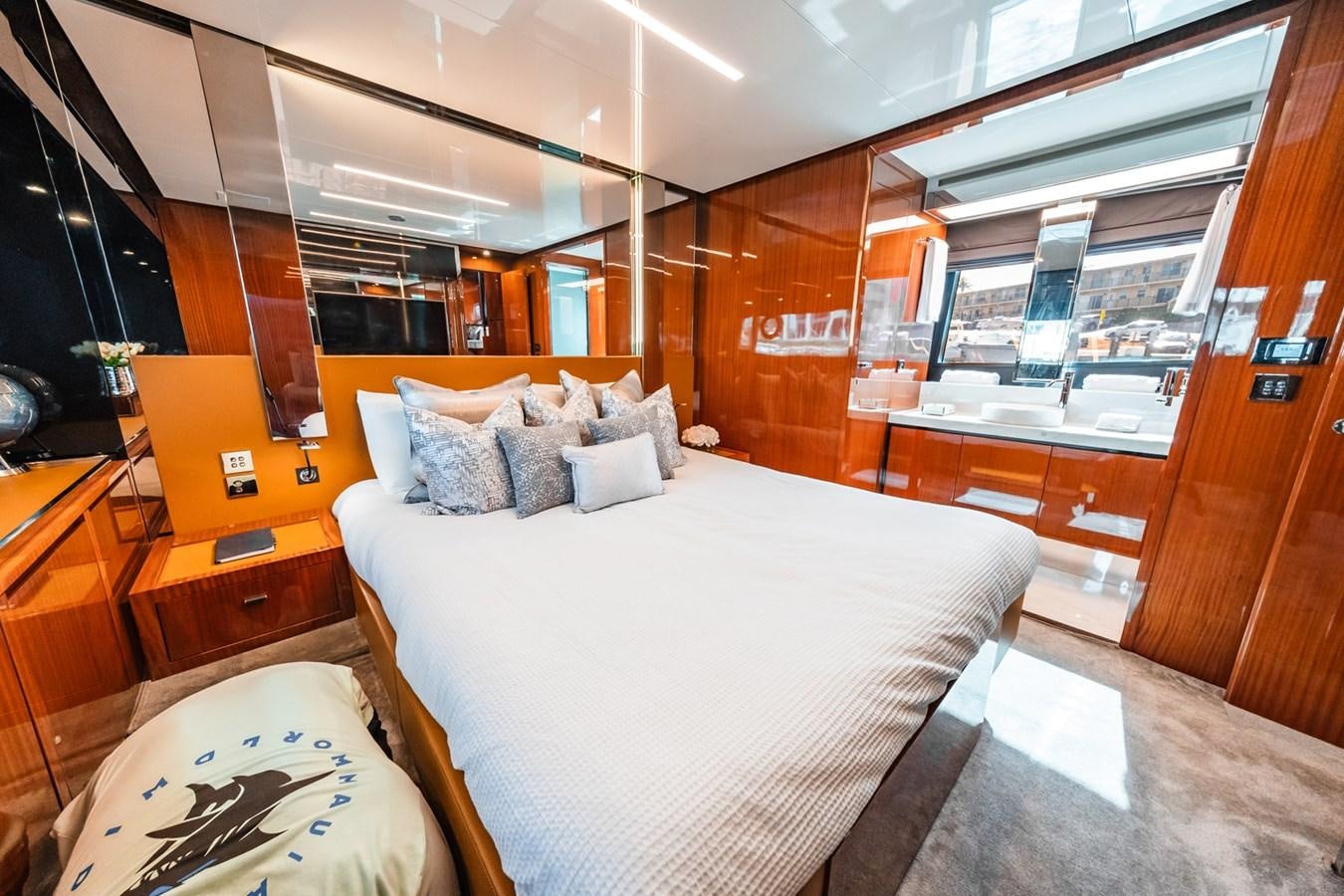 a room with a bed and a table aboard REGENCY Yacht for Sale