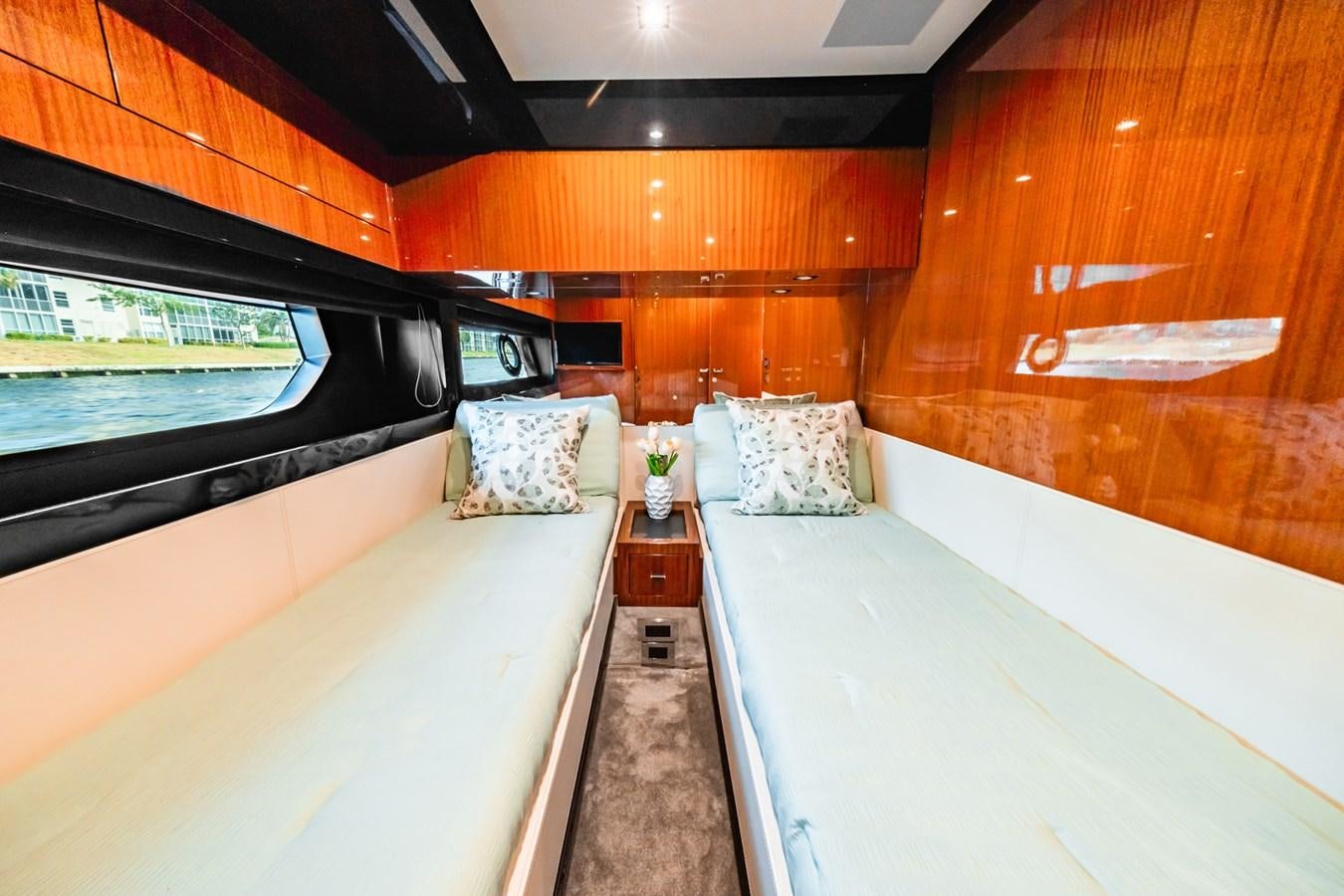 a room with a bed and a window aboard REGENCY Yacht for Sale