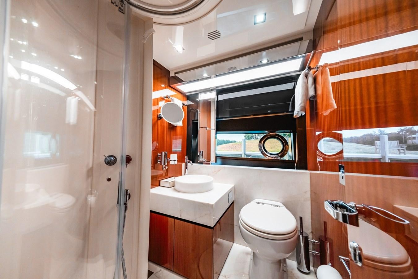 a bathroom with a toilet and sink aboard REGENCY Yacht for Sale