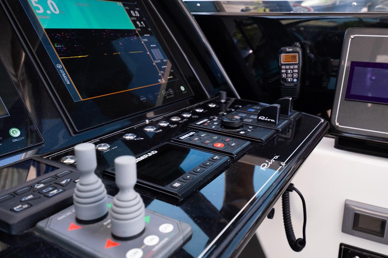 a control panel with a screen and a monitor aboard REGENCY Yacht for Sale