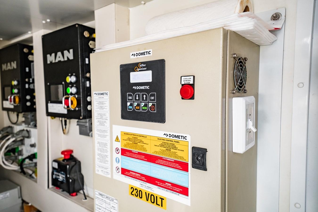 a white wall with a sign and switches aboard REGENCY Yacht for Sale