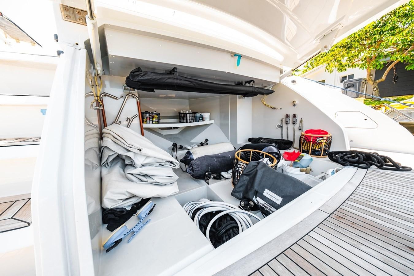 a white tent with a black and white tent and a black car aboard REGENCY Yacht for Sale