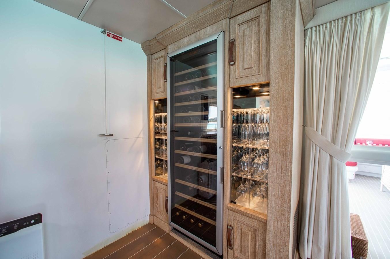 a kitchen with a glass case aboard PEGASUS IX Yacht for Sale