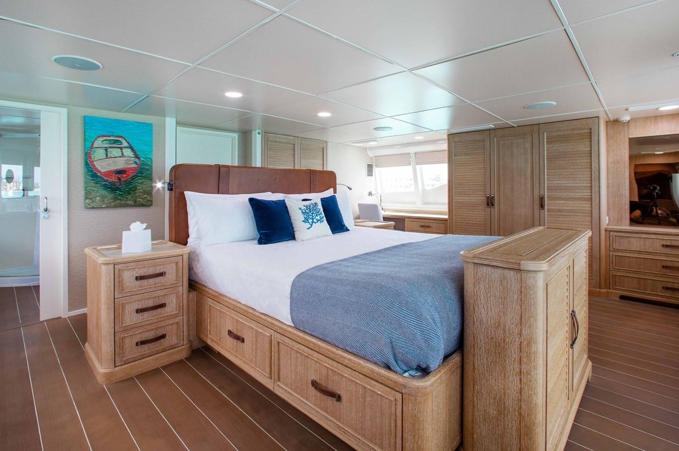 a bedroom with a bed and cabinets aboard PEGASUS IX Yacht for Sale