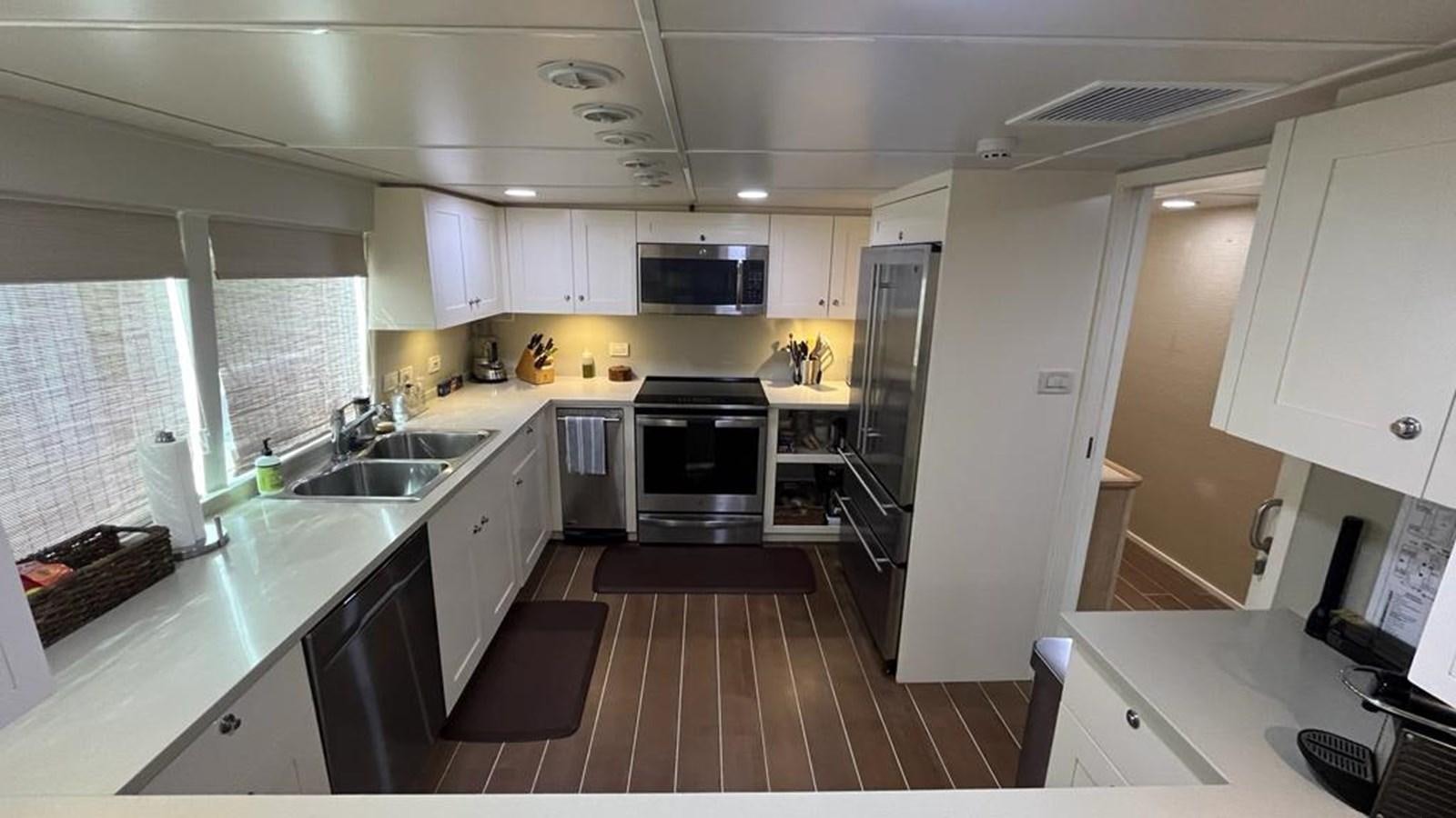 a kitchen with white cabinets aboard PEGASUS IX Yacht for Sale