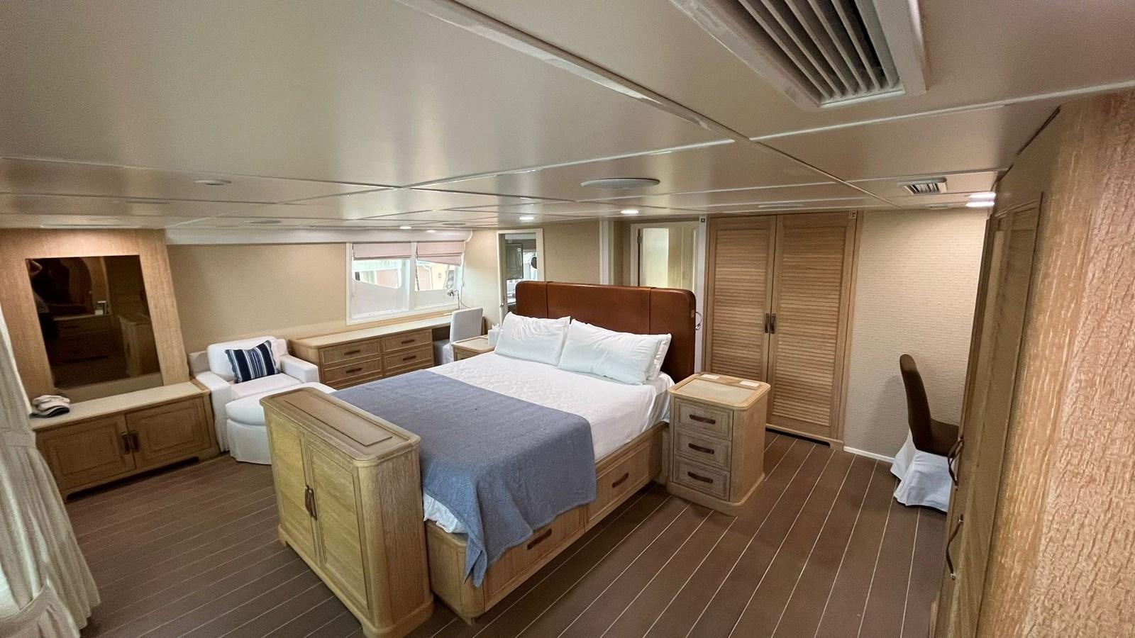 a room with a bed and a chair aboard PEGASUS IX Yacht for Sale