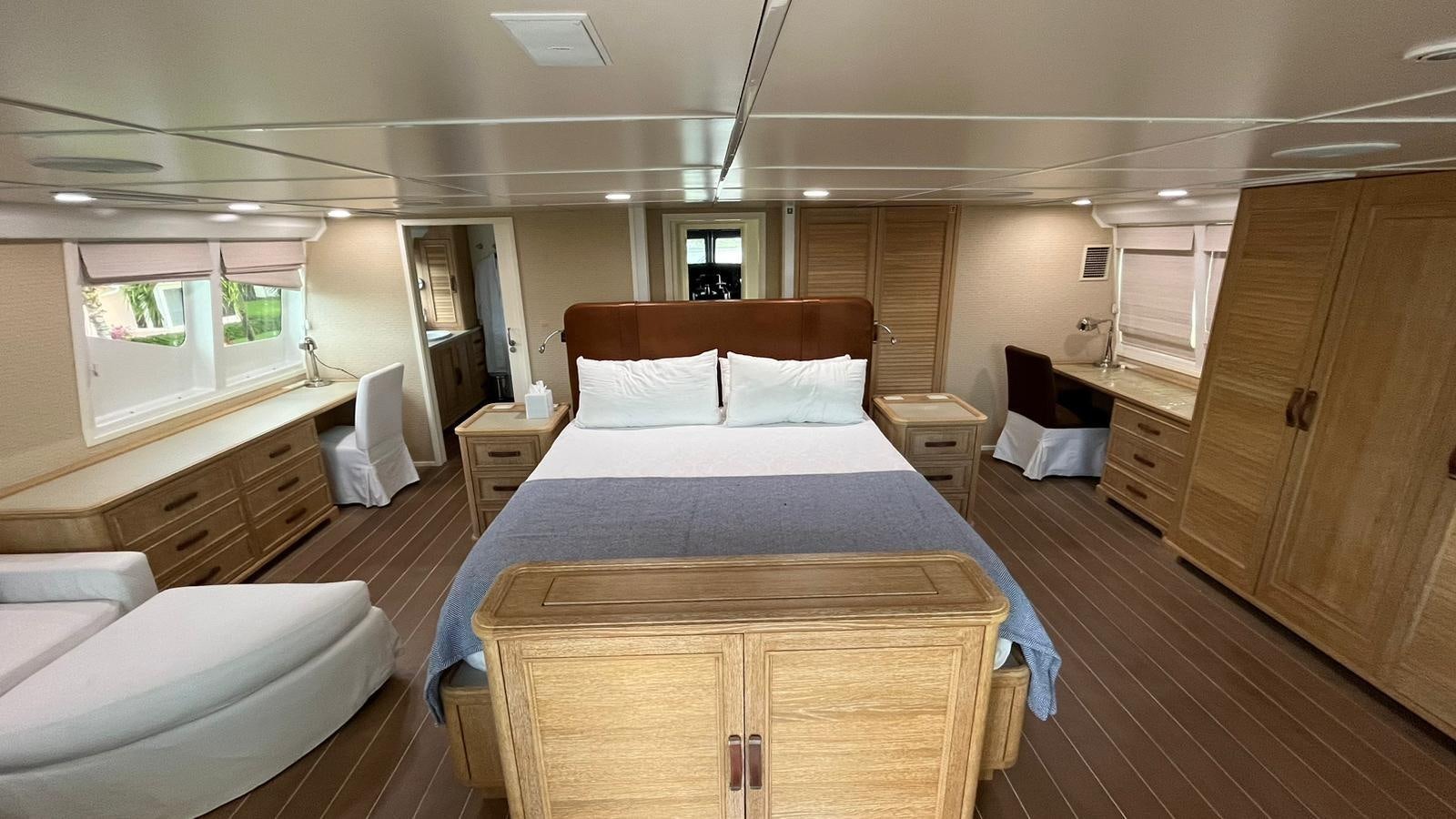 a room with a bed and a desk aboard PEGASUS IX Yacht for Sale