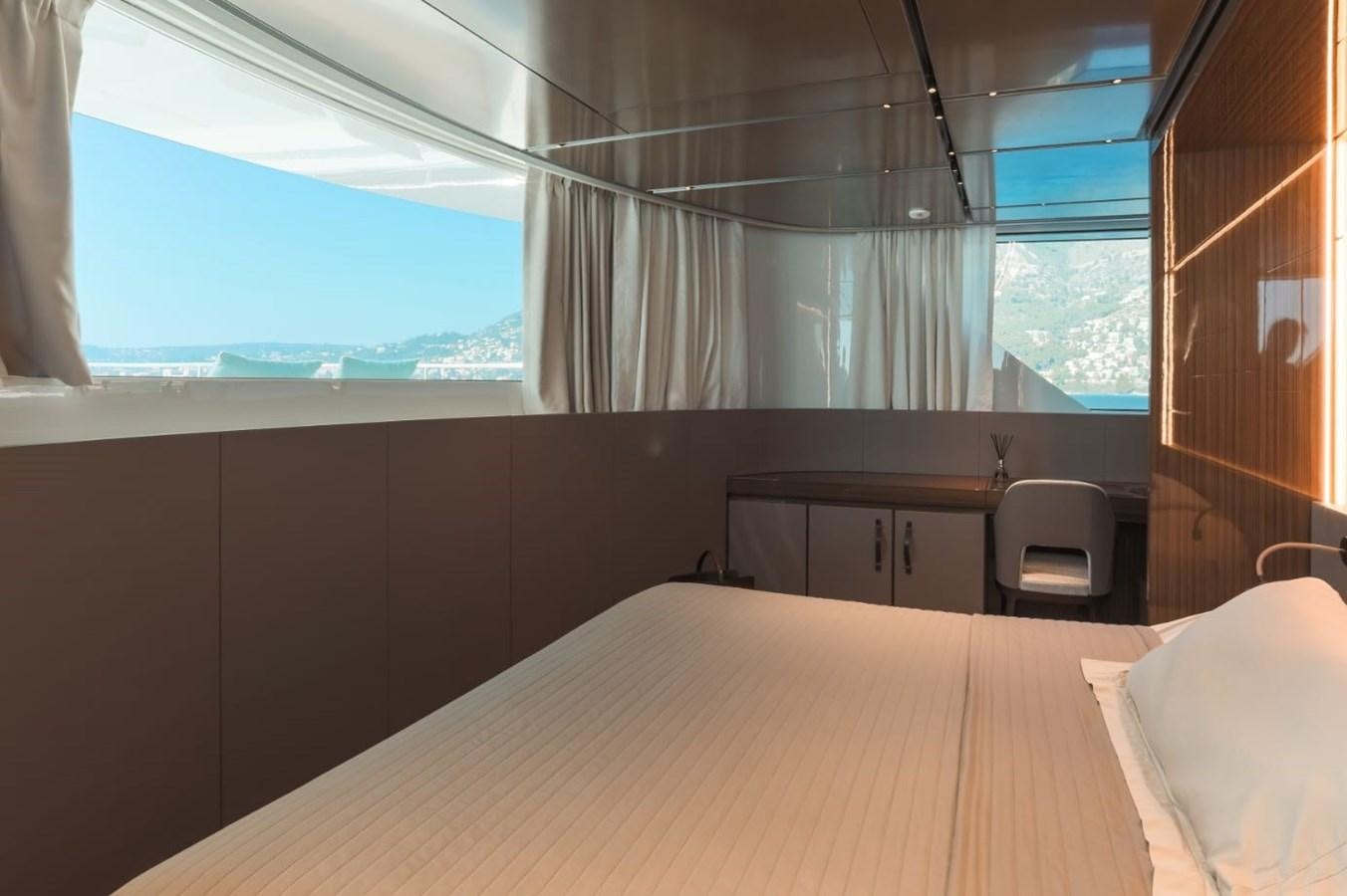 a room with a bed and a desk aboard STRADIVARIUS Yacht for Sale