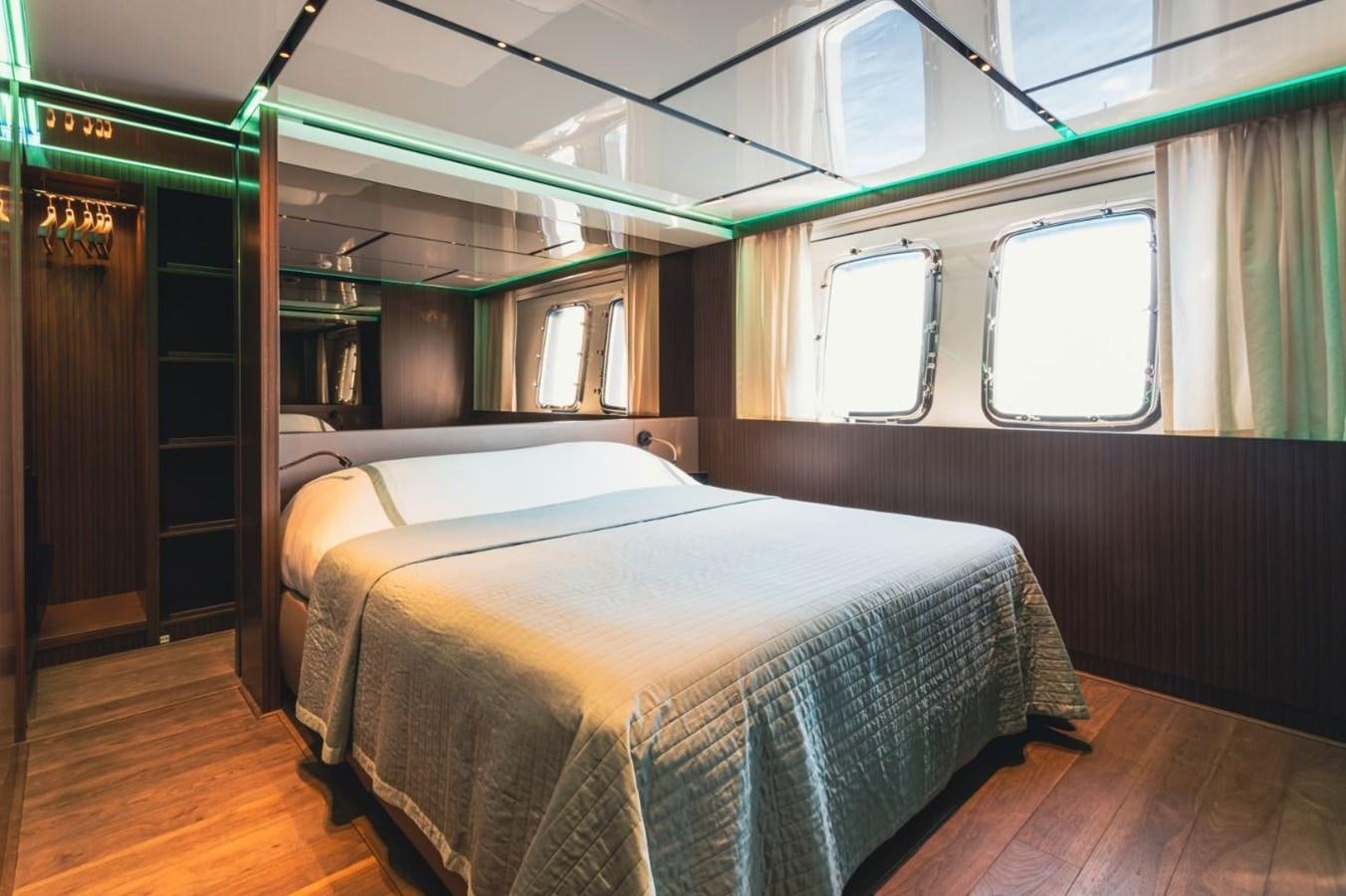 a room with a bed and a window aboard STRADIVARIUS Yacht for Sale