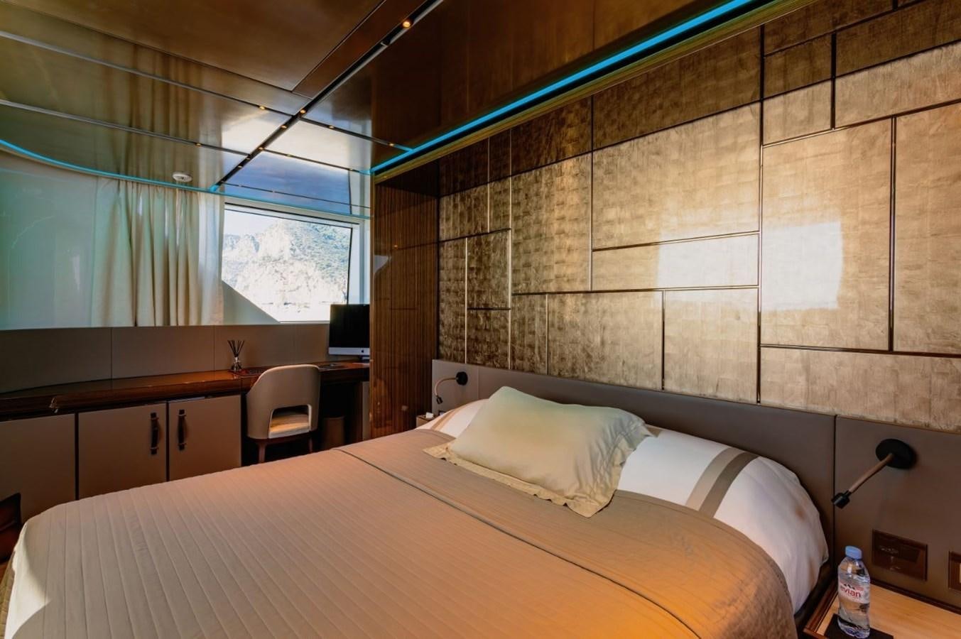 a room with a bed and a desk aboard STRADIVARIUS Yacht for Sale