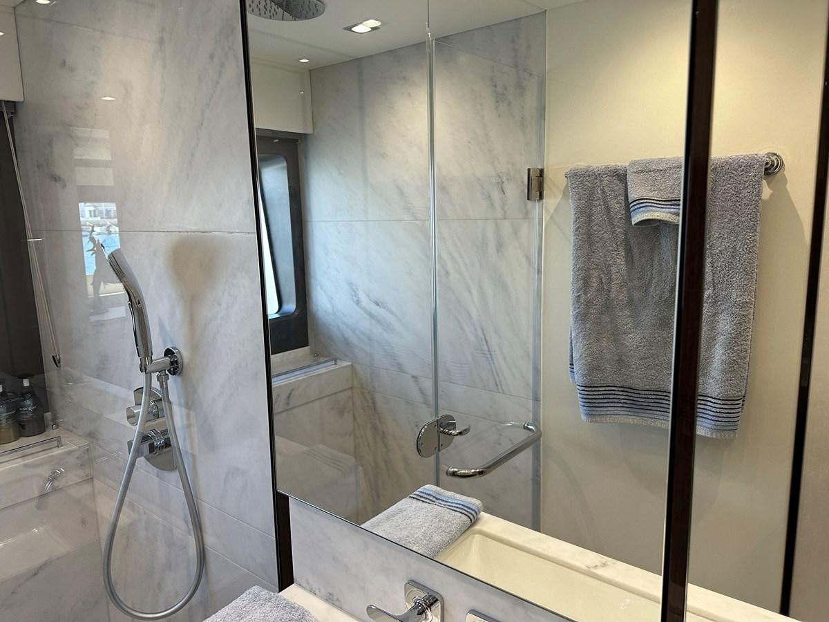 a bathroom with a glass shower aboard K NUK Yacht for Sale