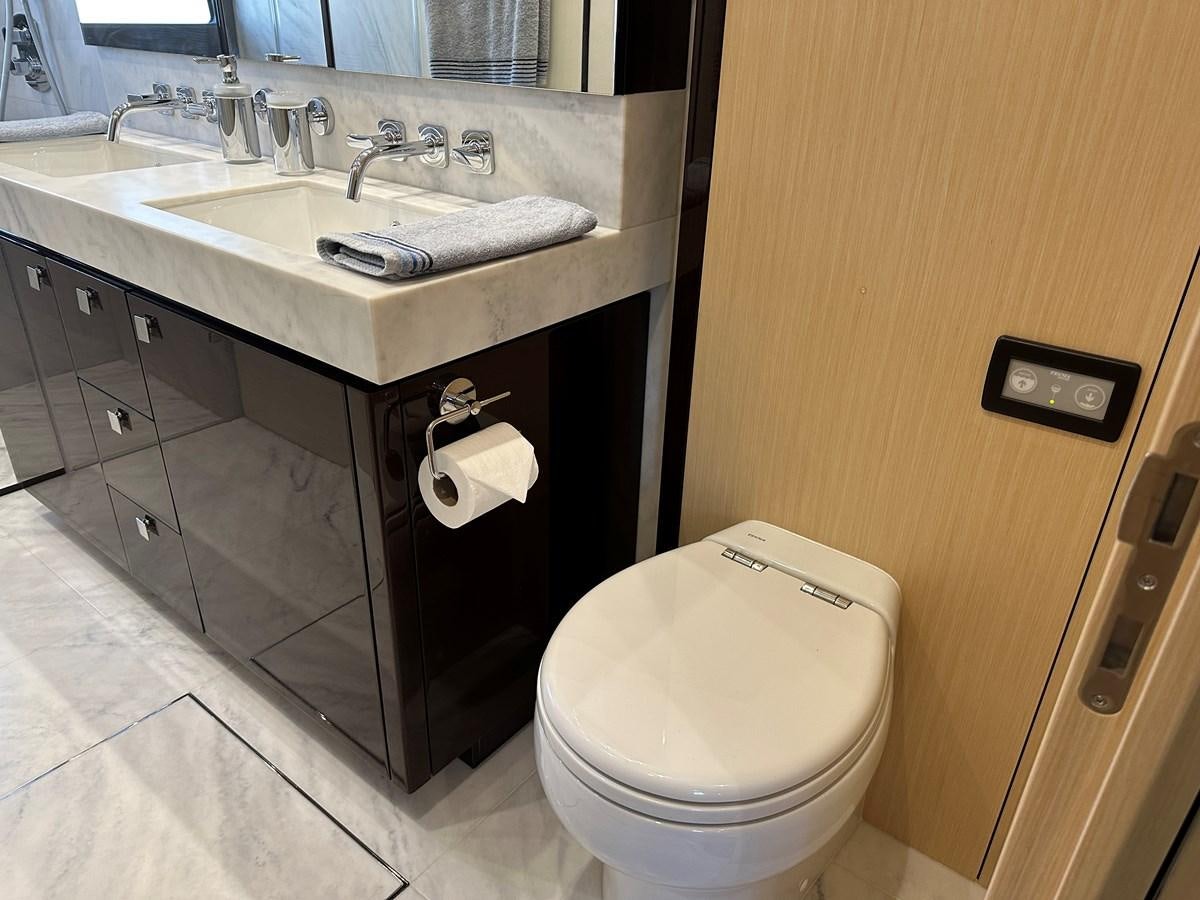 a bathroom with a sink toilet and a mirror aboard K NUK Yacht for Sale