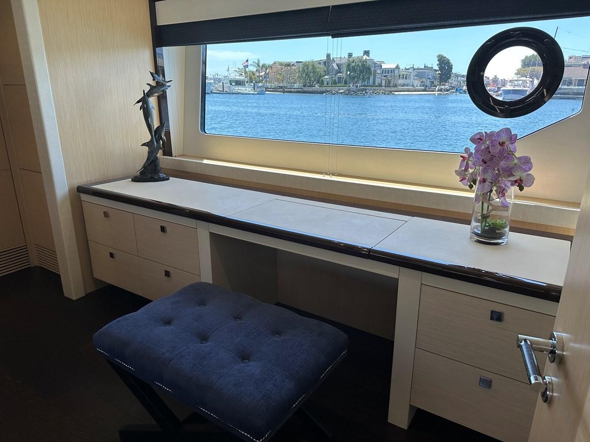 a room with a window and a desk with a view of a city aboard K NUK Yacht for Sale