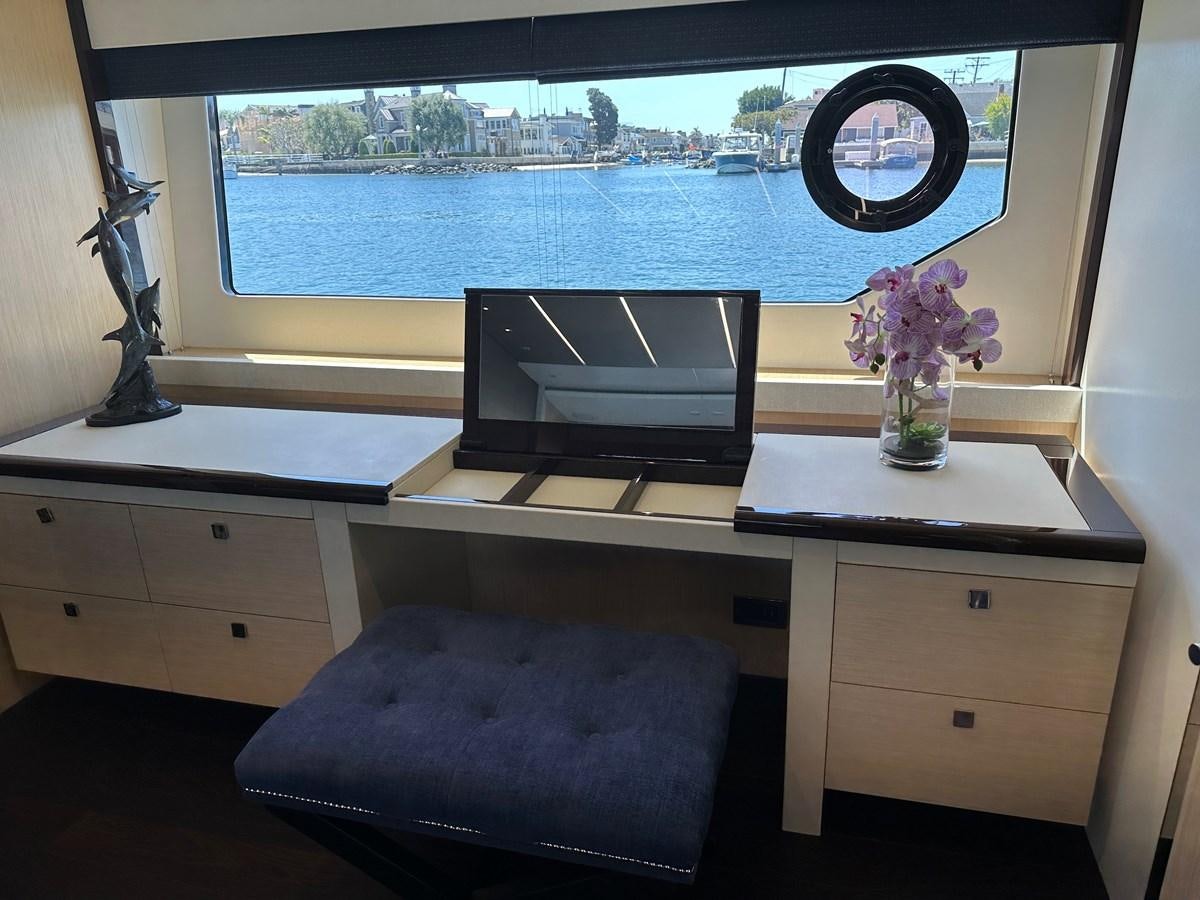 a desk with a computer and a television on it aboard K NUK Yacht for Sale