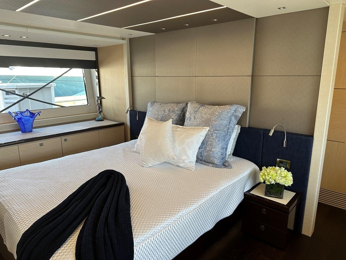 a bed with white sheets and pillows aboard K NUK Yacht for Sale