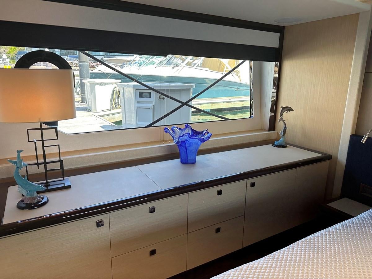 a room with a window and a desk with a lamp and a window aboard K NUK Yacht for Sale