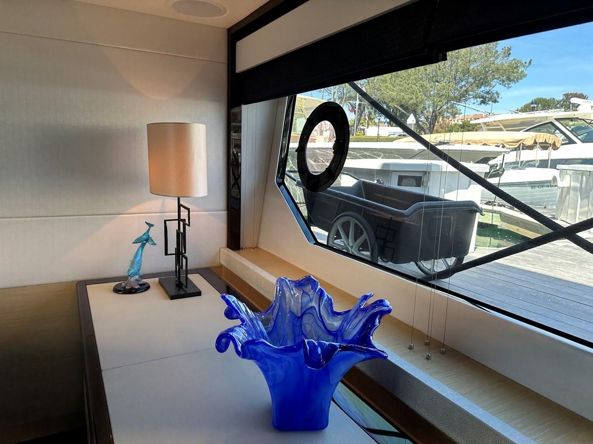 a window with a blue object on it and a lamp on the side aboard K NUK Yacht for Sale