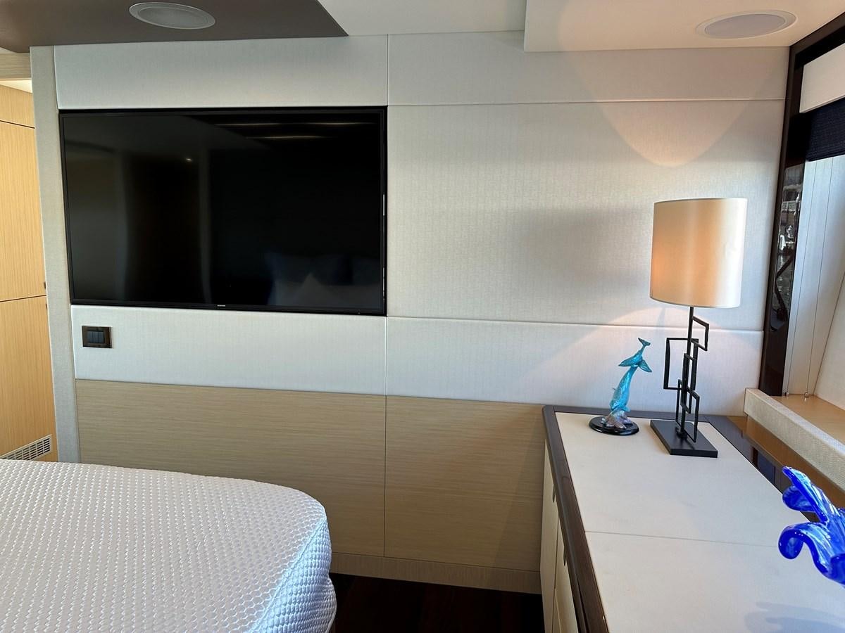 a bedroom with a large mirror aboard K NUK Yacht for Sale