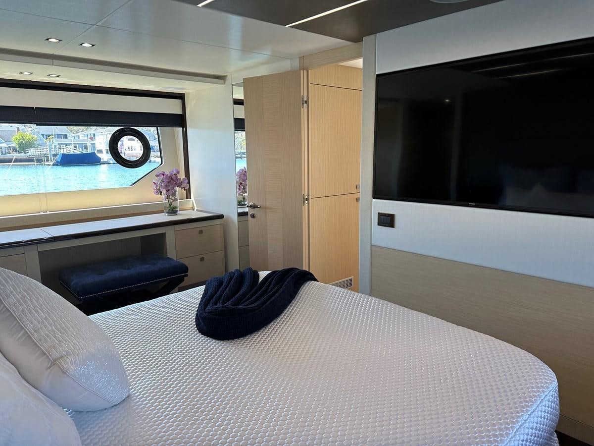 a bedroom with a bed and a tv aboard K NUK Yacht for Sale