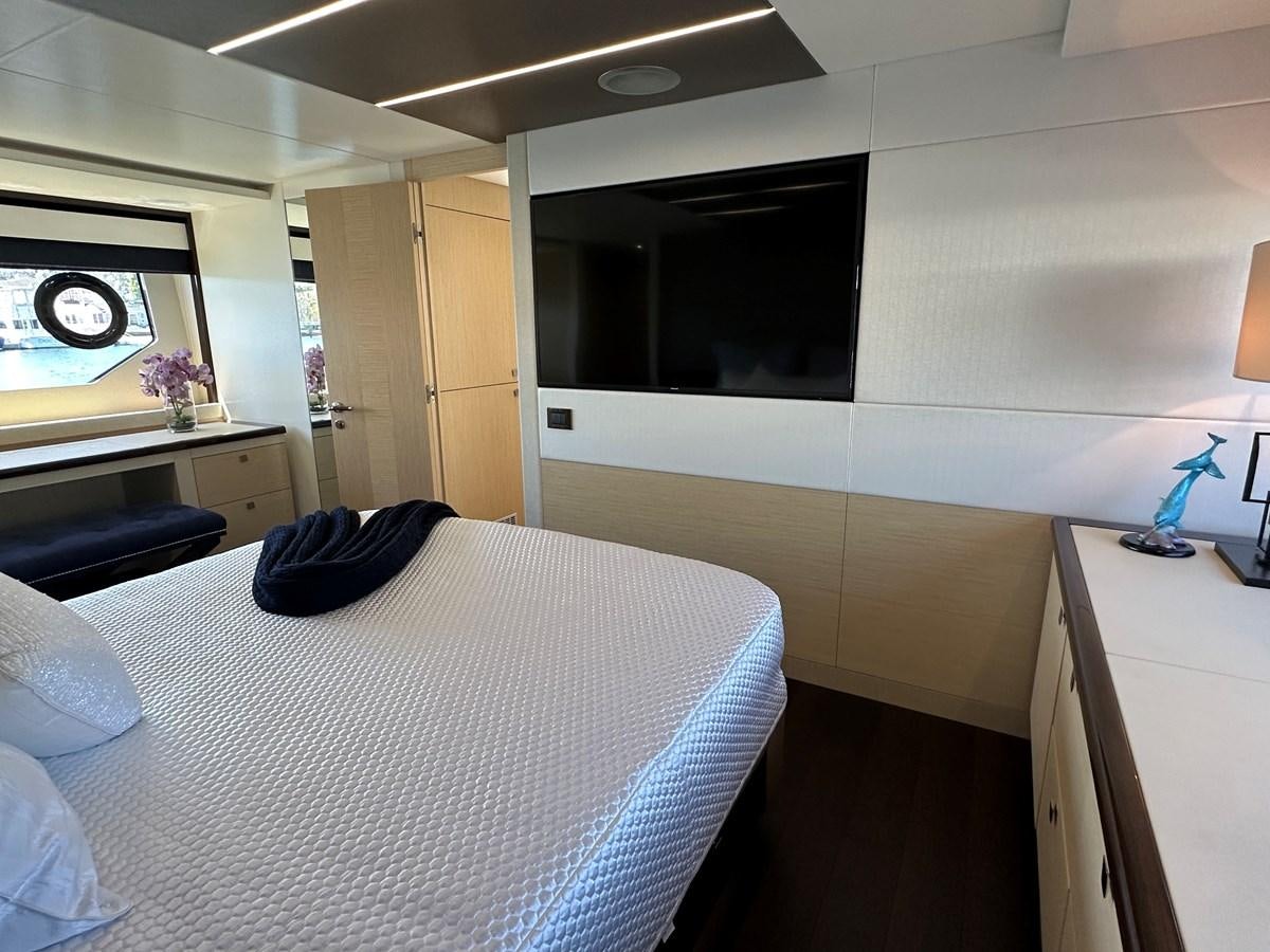 a bedroom with a bed and a tv aboard K NUK Yacht for Sale