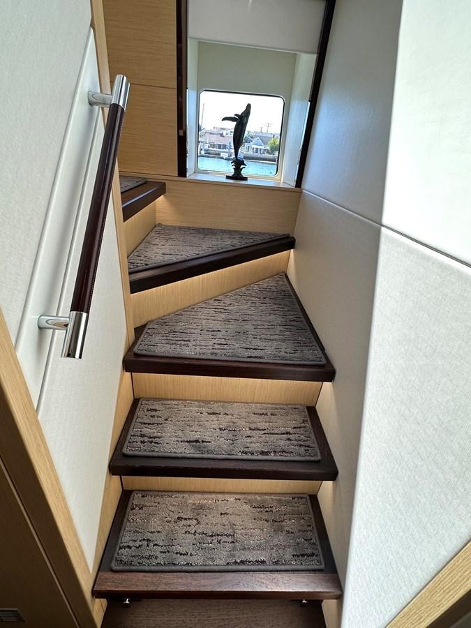 a wooden staircase with a glass door aboard K NUK Yacht for Sale