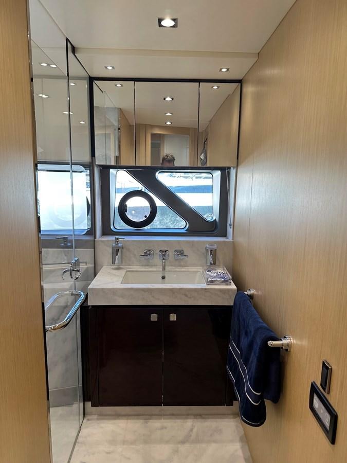 a bathroom with a sink and tv aboard K NUK Yacht for Sale