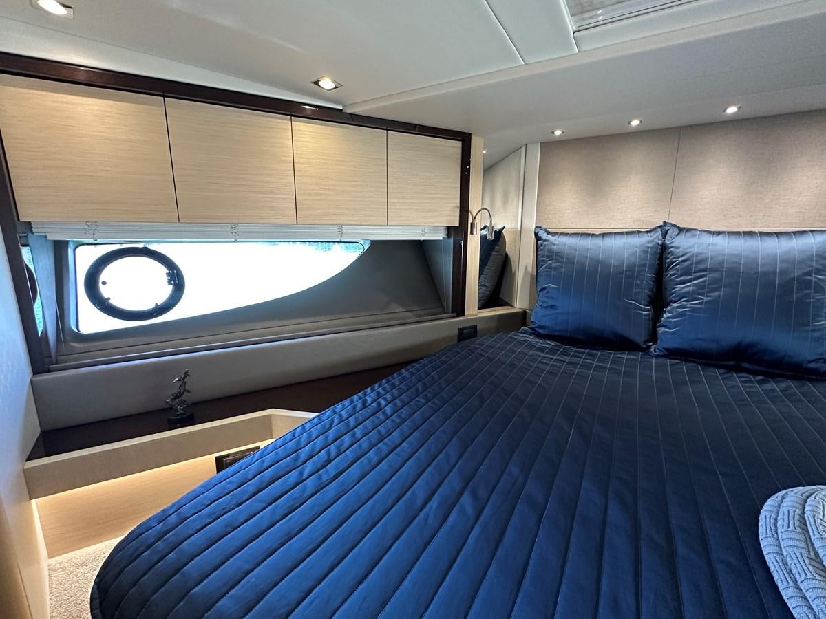 a bed with a blue comforter aboard K NUK Yacht for Sale