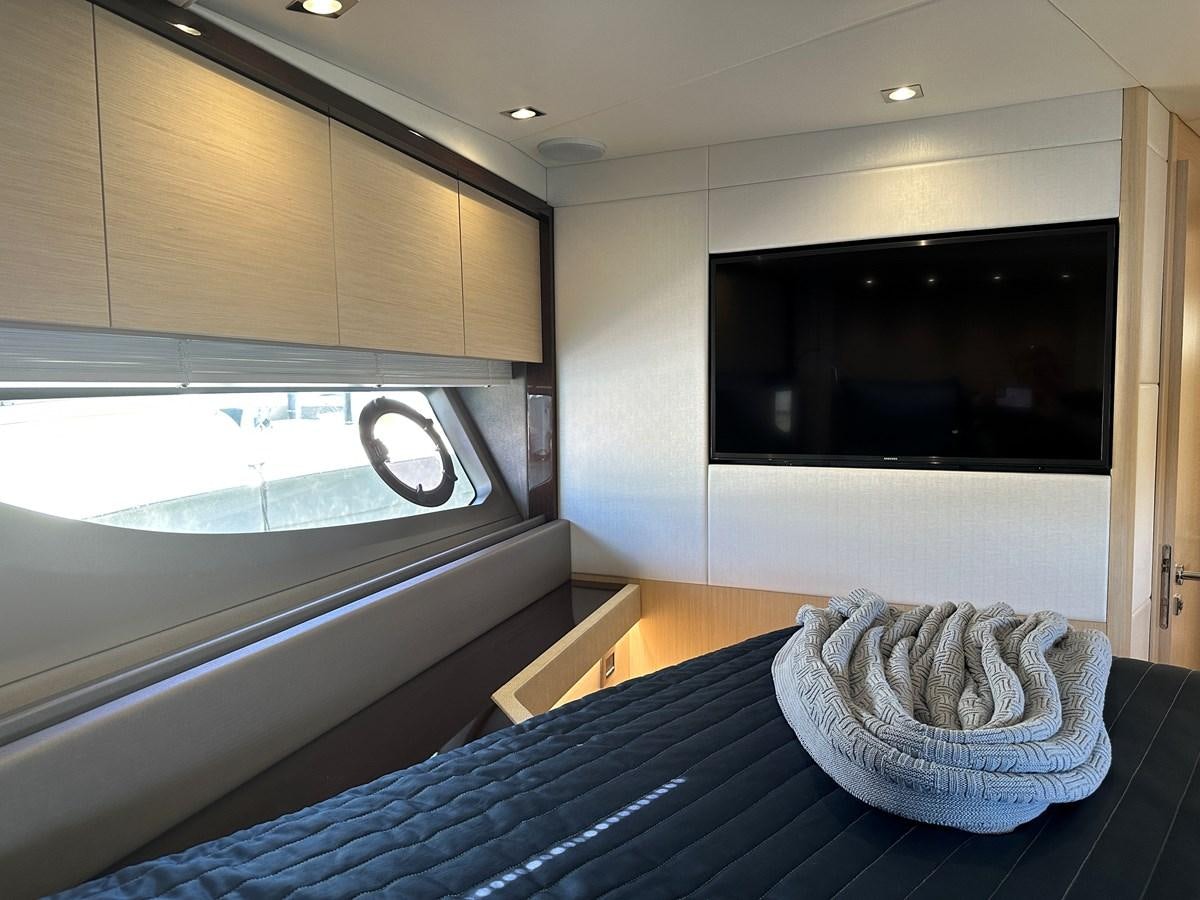 a bedroom with a large tv aboard K NUK Yacht for Sale