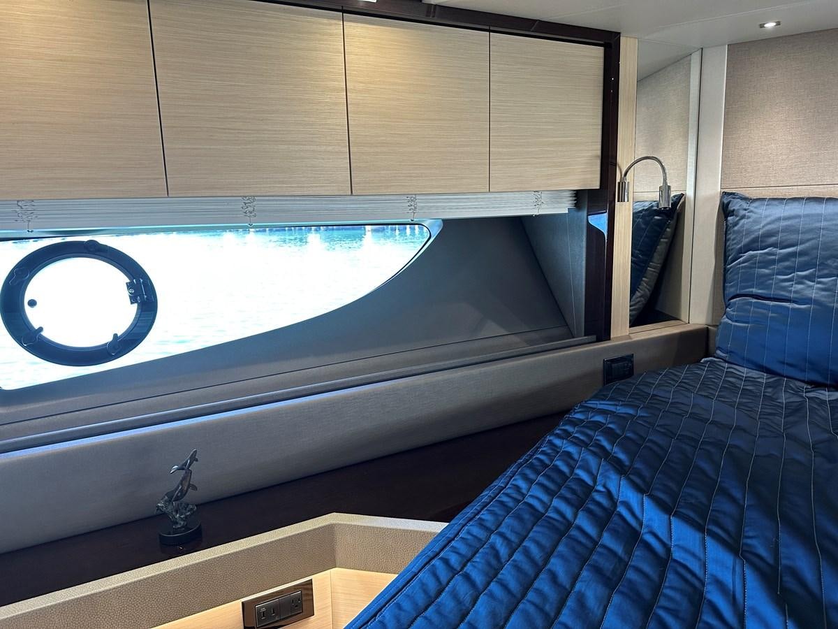 a bed with a blue blanket aboard K NUK Yacht for Sale