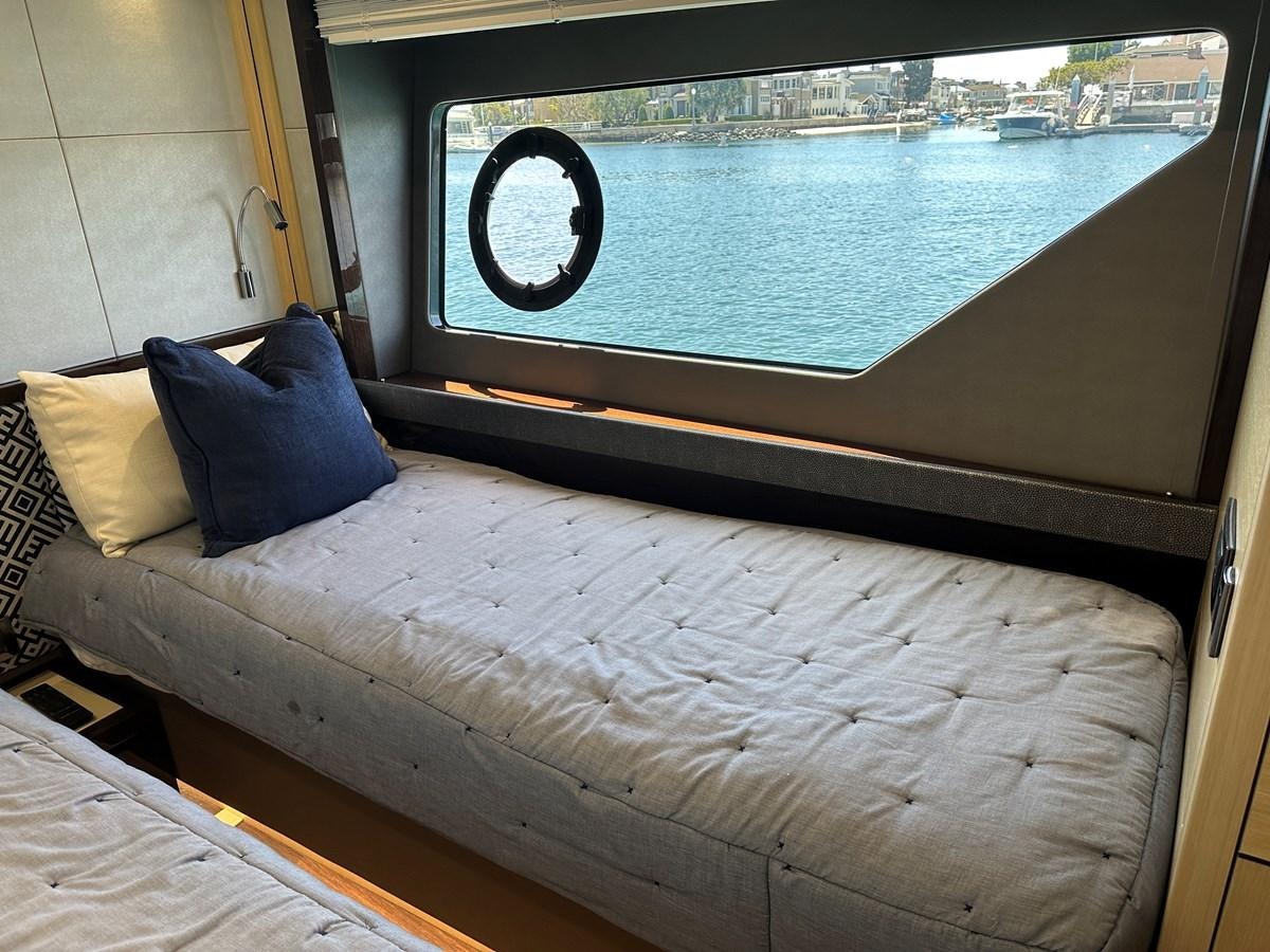 a bed next to a window aboard K NUK Yacht for Sale