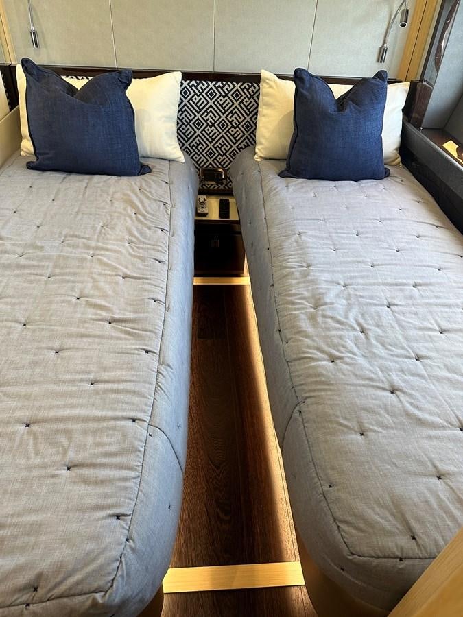 a bed with a wood headboard aboard K NUK Yacht for Sale