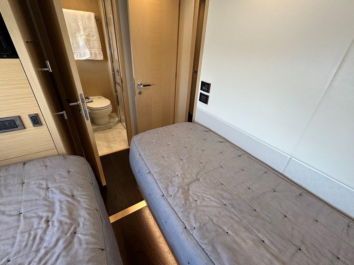 a bedroom with a bed and a closet aboard K NUK Yacht for Sale