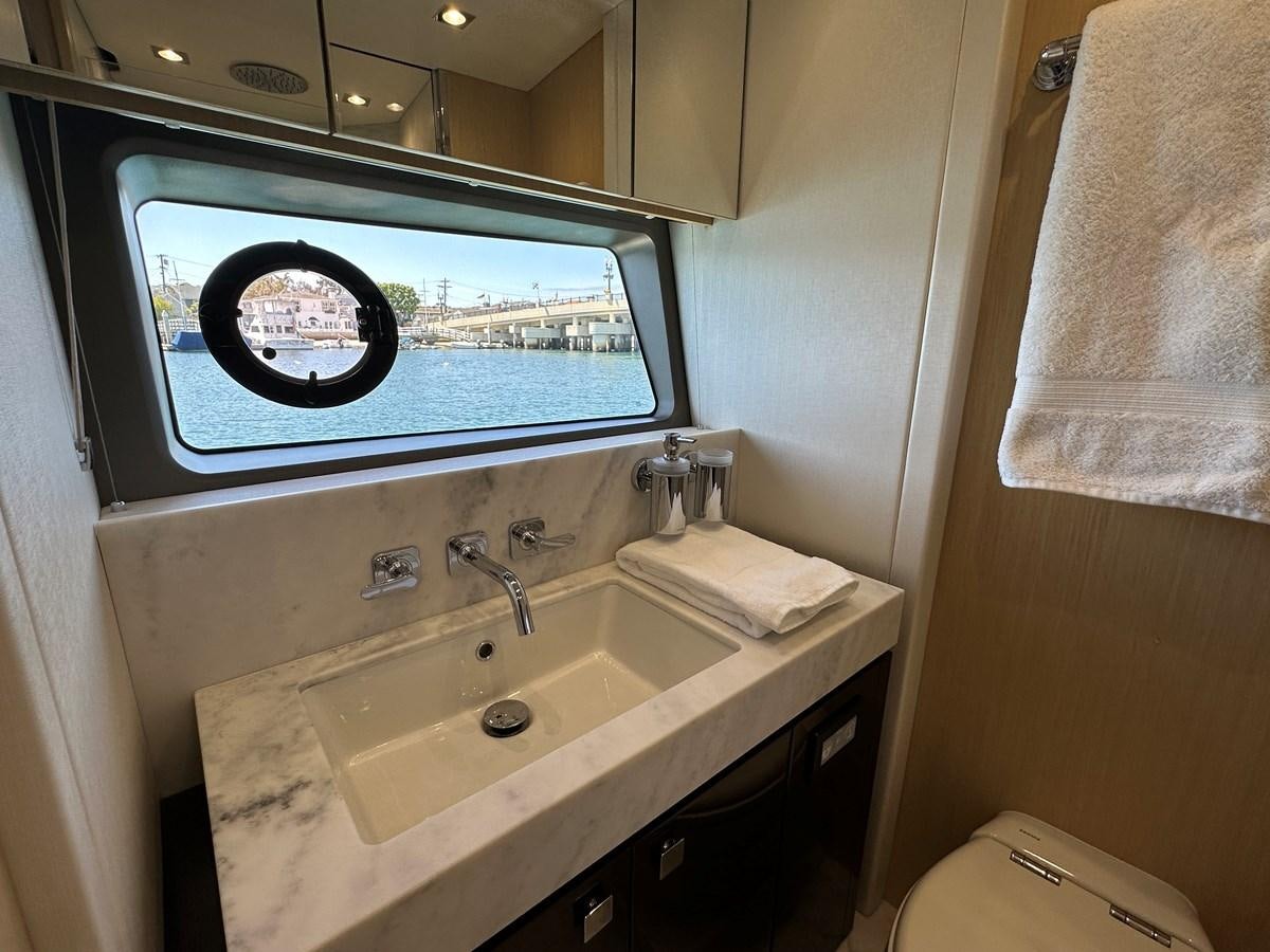 a bathroom with a sink and a tv aboard K NUK Yacht for Sale