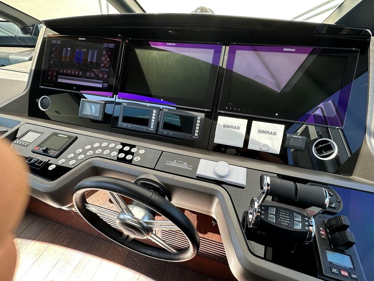 a hand holding a computer aboard K NUK Yacht for Sale