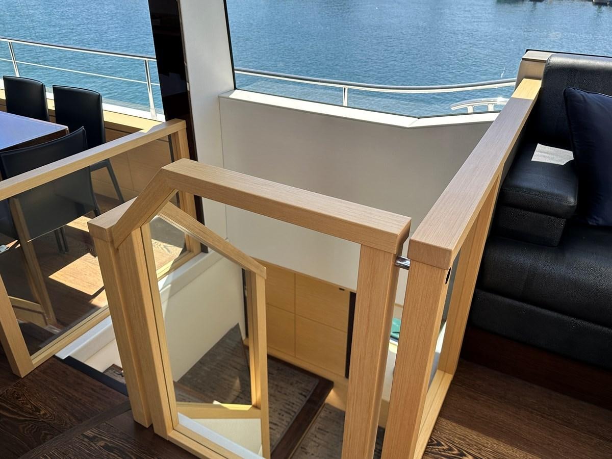 a wooden bench next to a couch aboard K NUK Yacht for Sale